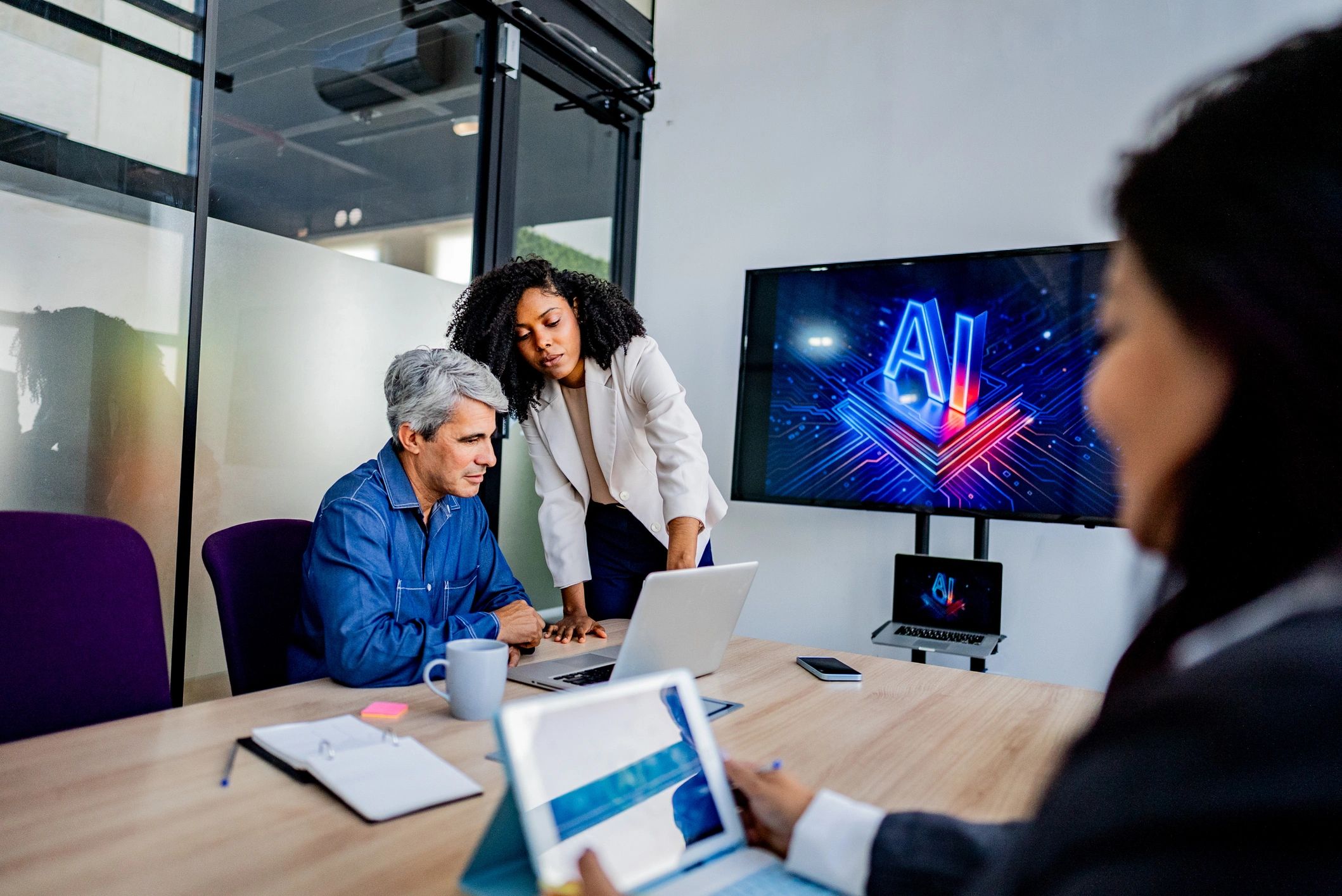Business team collaborating around a laptop
