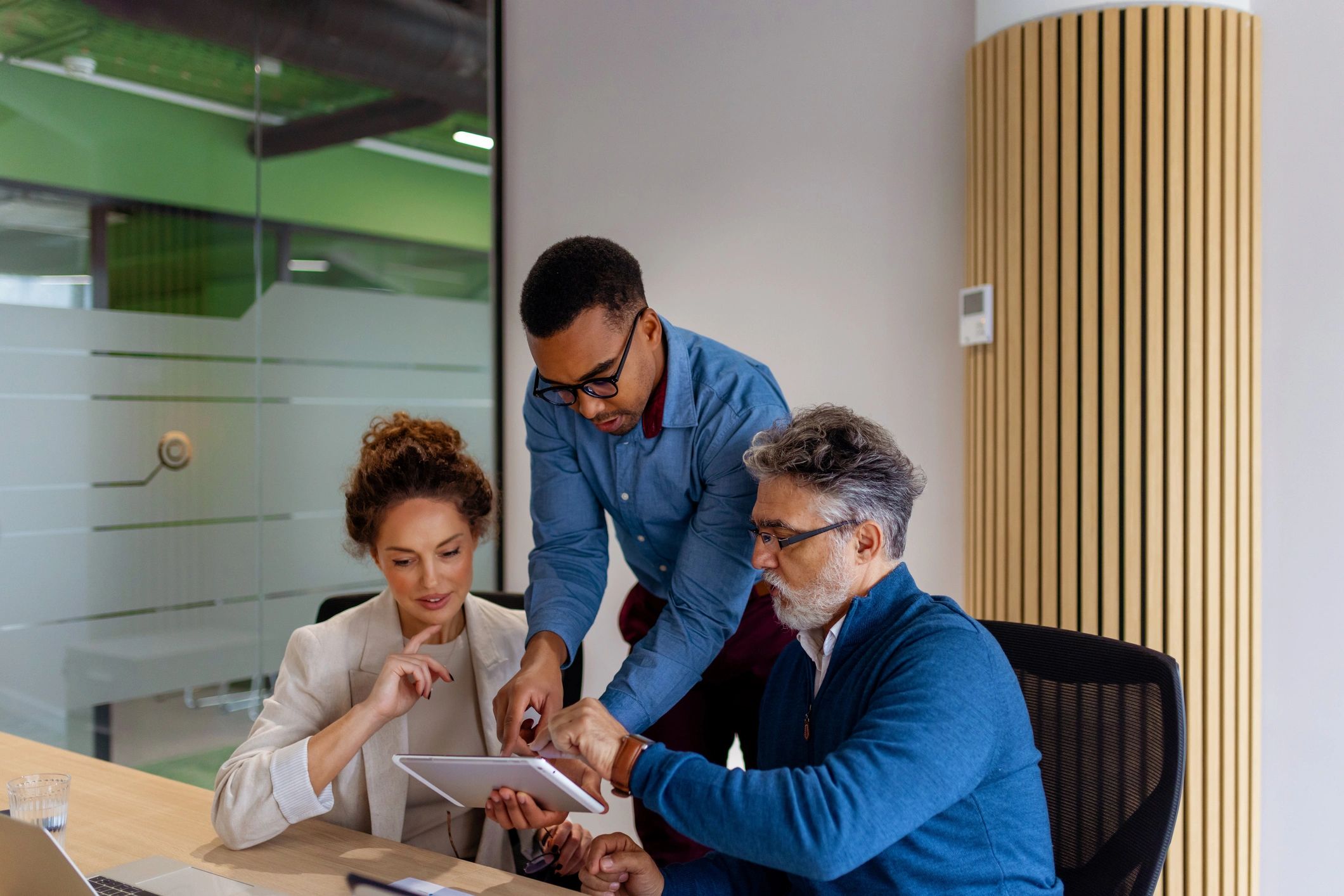 Business professionals collaborating on a tablet