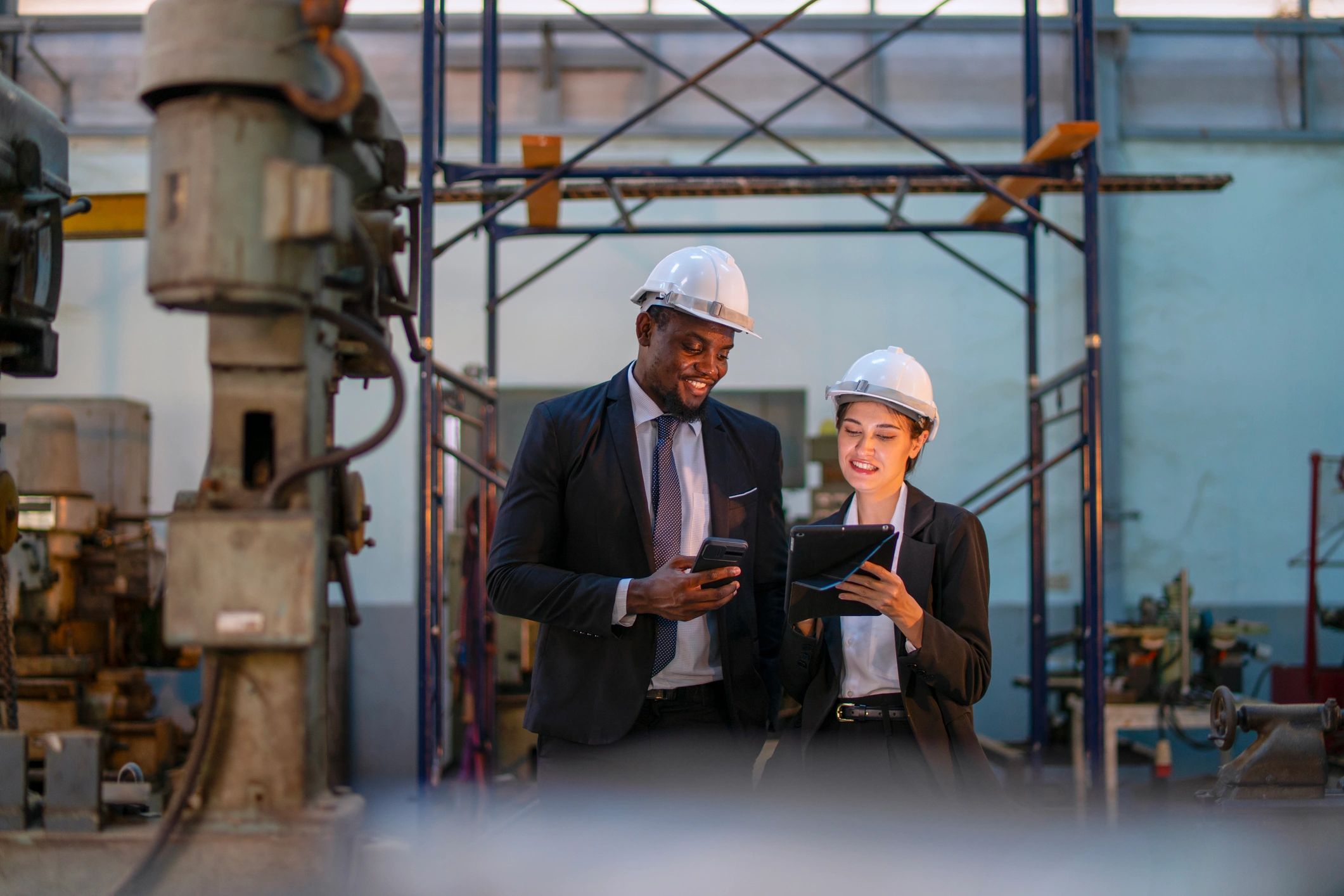 Engineer and business professional meeting in a workshop